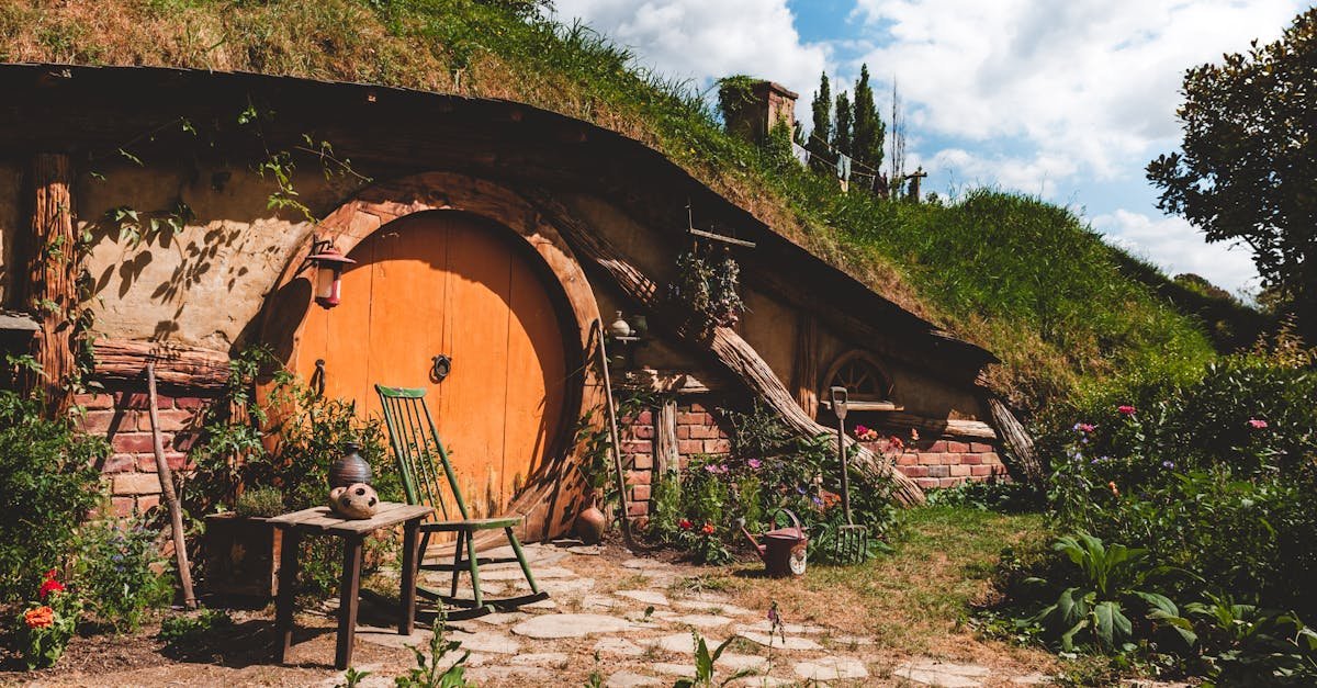 Explore a cozy hobbit house nestled in New Zealand's lush countryside, perfect for a rustic getaway.
